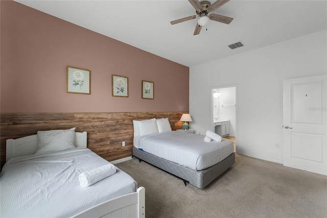 carpeted bedroom featuring ceiling fan and ensuite bathroom