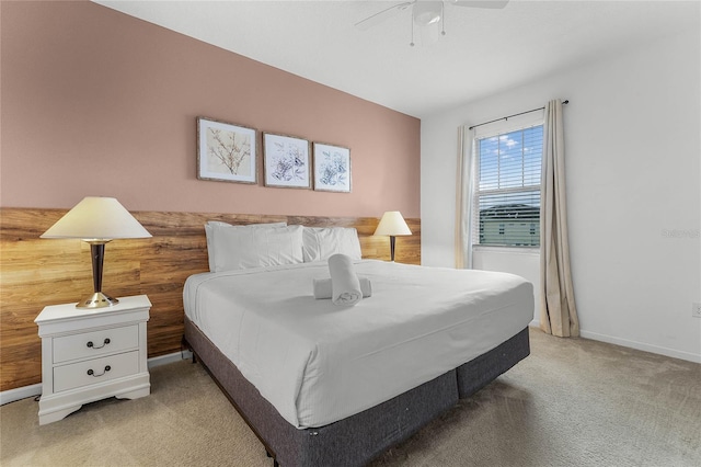 bedroom with ceiling fan and light carpet