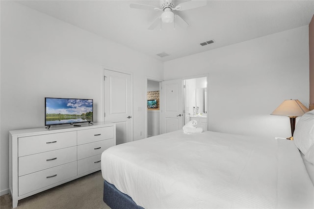 bedroom with carpet flooring, ceiling fan, and ensuite bath