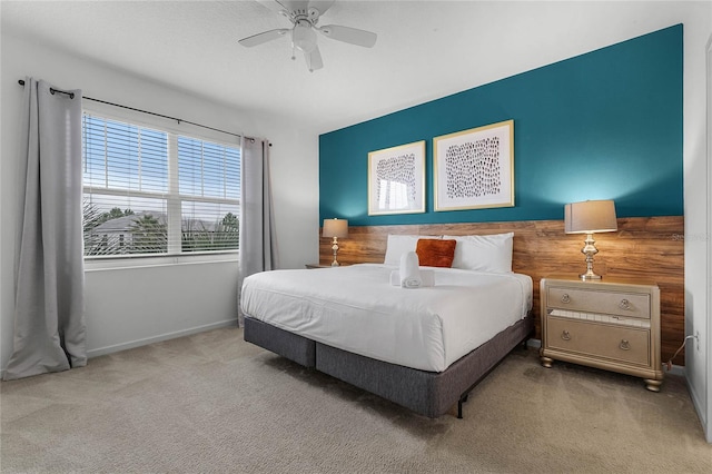 bedroom with ceiling fan and light colored carpet