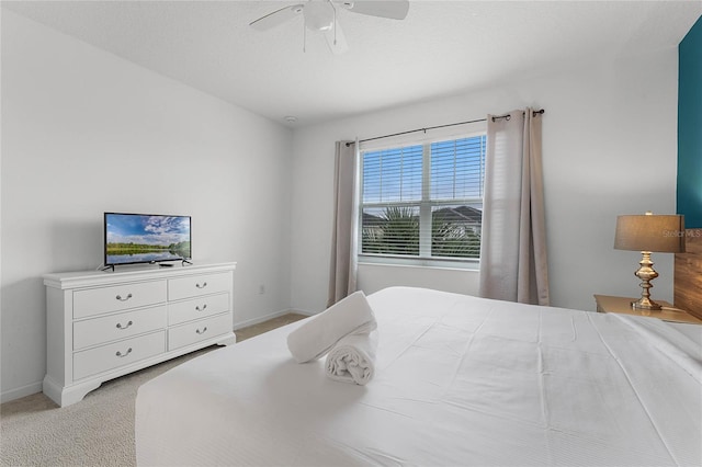 bedroom featuring ceiling fan and light carpet