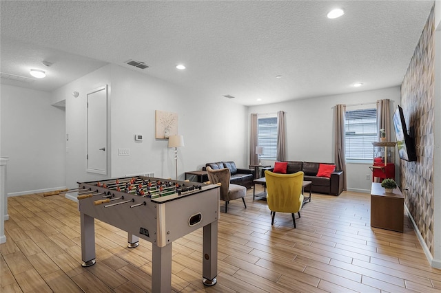 playroom with a textured ceiling