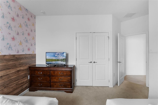 bedroom featuring carpet and a closet