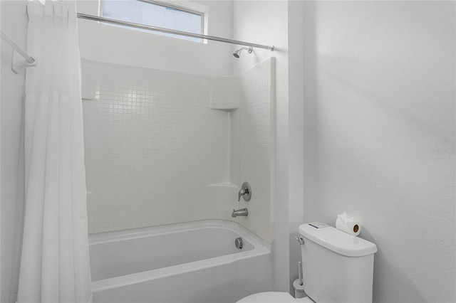 bathroom with shower / bath combination with curtain and toilet