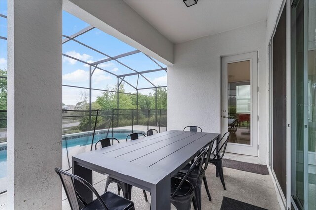 view of patio / terrace featuring glass enclosure and a fenced in pool