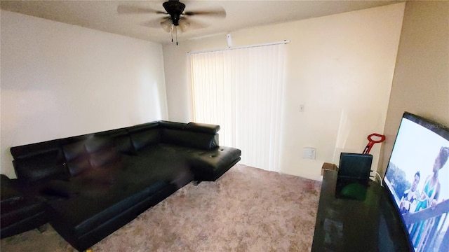 carpeted living room with ceiling fan