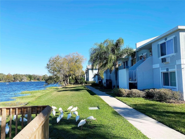 view of home's community featuring a yard and a water view