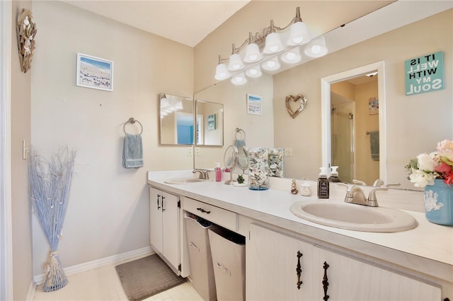 bathroom featuring tile patterned flooring, vanity, and a shower with door