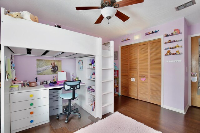 home office with ceiling fan and dark hardwood / wood-style floors