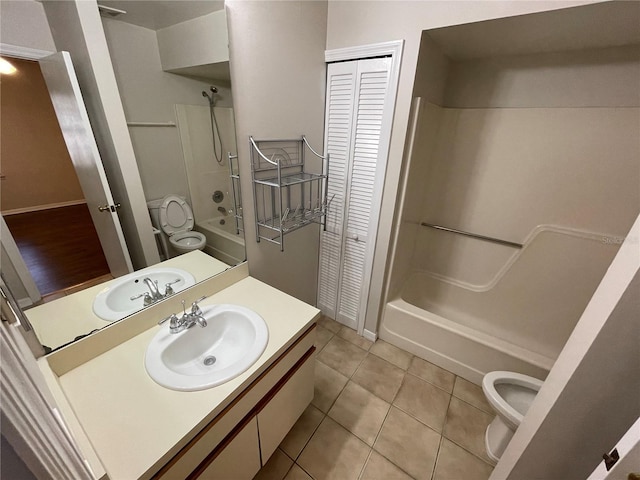 bathroom with shower / washtub combination, a closet, tile patterned flooring, and vanity