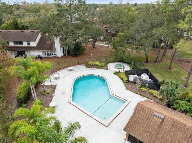 view of pool featuring a lawn and fence