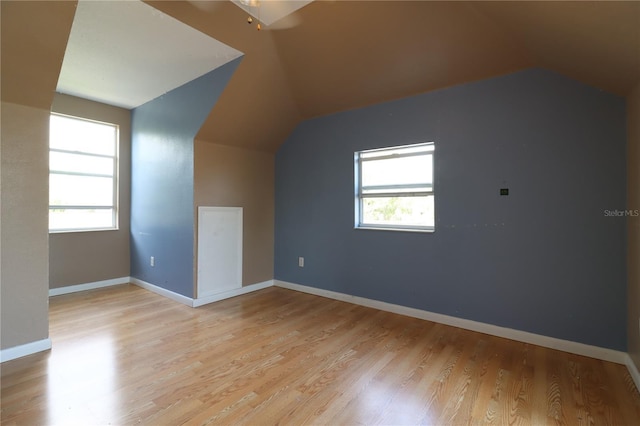 bonus room featuring lofted ceiling and light wood-type flooring