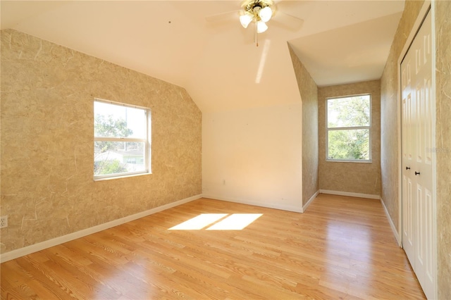 bonus room with vaulted ceiling and light wood-type flooring