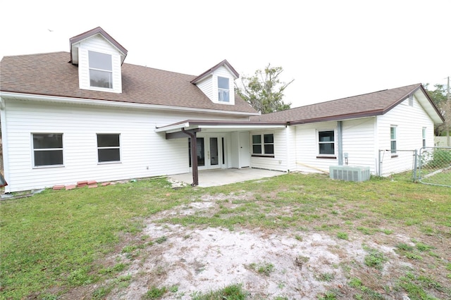 back of property with a lawn, a patio, and central air condition unit