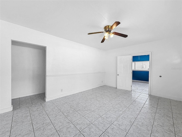 tiled empty room with ceiling fan