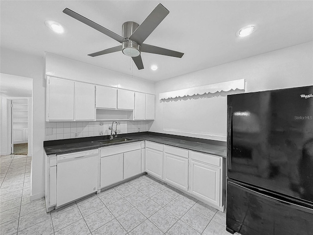 kitchen with black refrigerator, white cabinets, and dishwasher