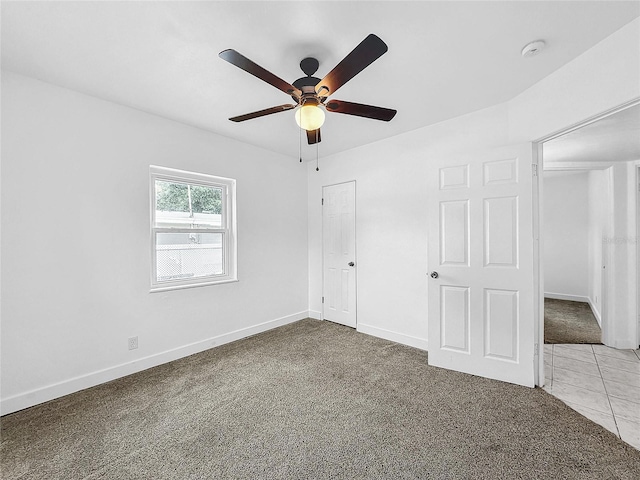 unfurnished bedroom featuring ceiling fan and light colored carpet