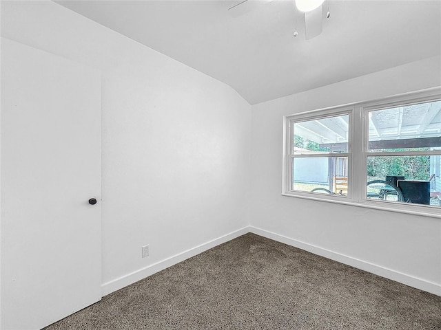 unfurnished room featuring lofted ceiling and carpet