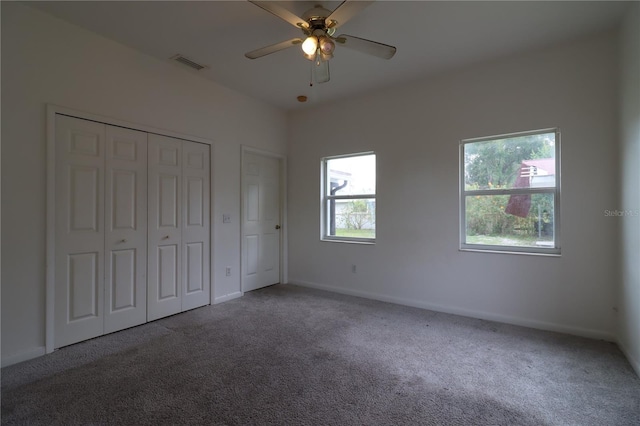 unfurnished bedroom with carpet, ceiling fan, and a closet