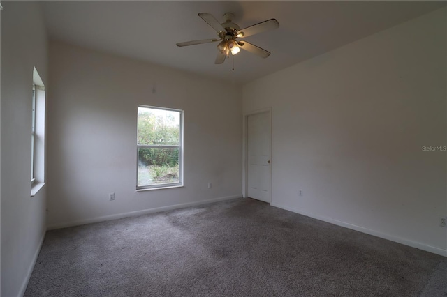 carpeted empty room featuring ceiling fan