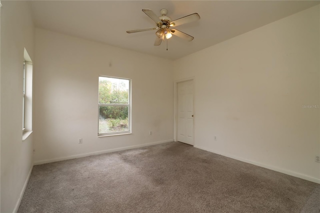 unfurnished room with ceiling fan and carpet flooring