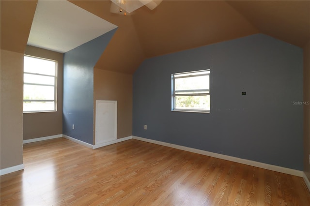 bonus room with lofted ceiling and light hardwood / wood-style floors