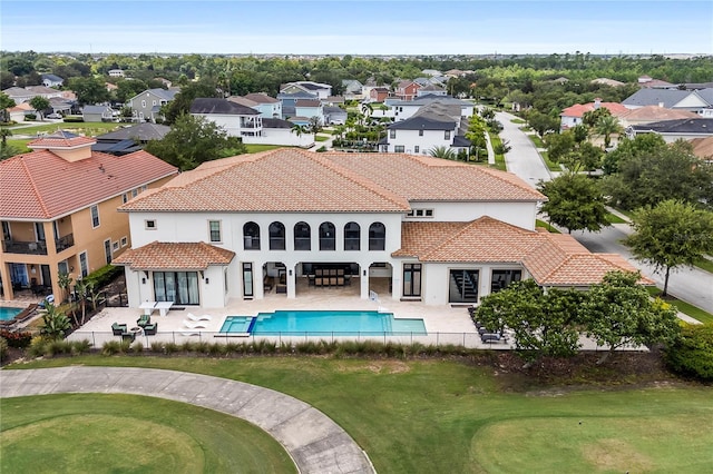 back of property featuring a lawn and a patio area