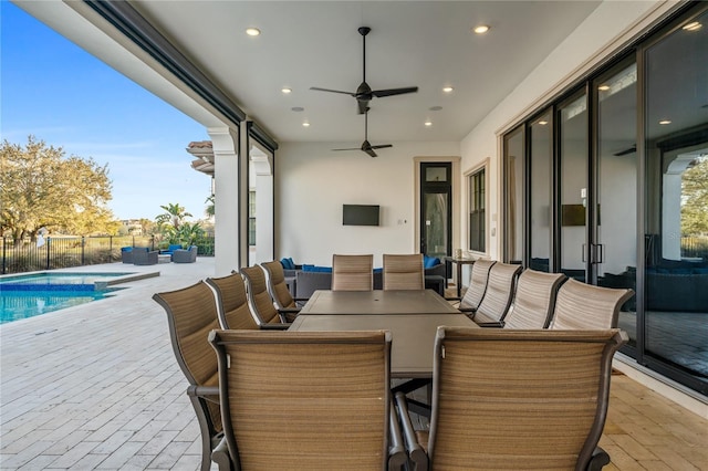 view of patio featuring ceiling fan, a fenced in pool, and an outdoor hangout area