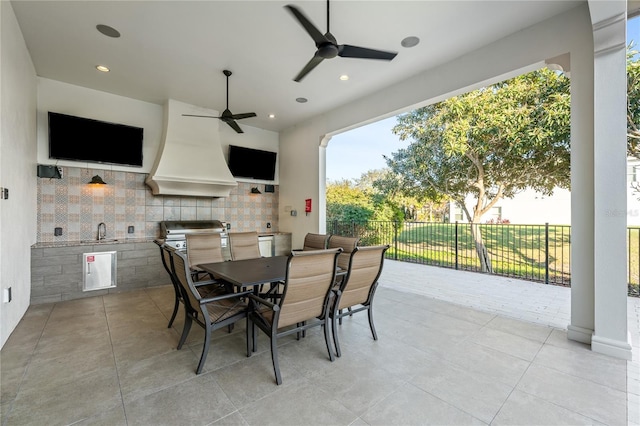 view of patio / terrace with grilling area, ceiling fan, sink, and exterior kitchen