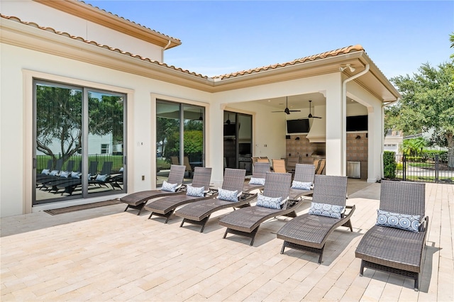 view of patio / terrace with ceiling fan and a deck