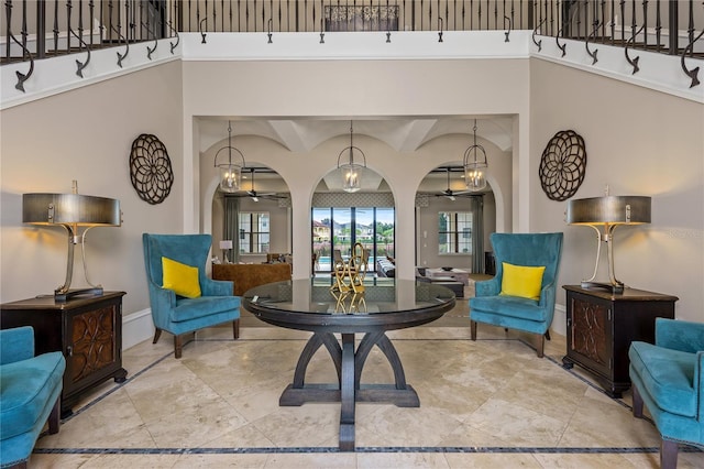 sitting room featuring beam ceiling and ceiling fan