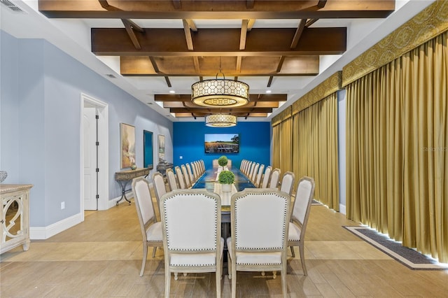 dining room with beamed ceiling, a chandelier, and light hardwood / wood-style floors