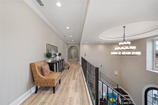 hall featuring light hardwood / wood-style floors and crown molding