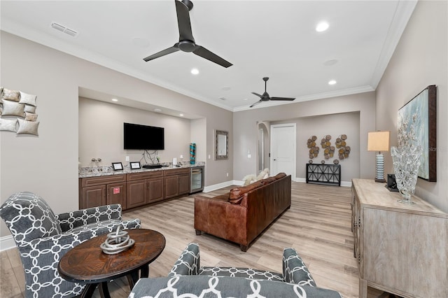 living room with wine cooler, light hardwood / wood-style flooring, ceiling fan, and crown molding