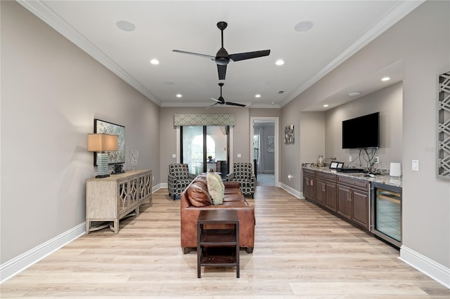 living room with light hardwood / wood-style flooring, wine cooler, ceiling fan, and crown molding