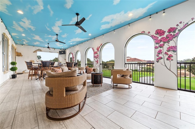 view of patio with an outdoor living space and ceiling fan