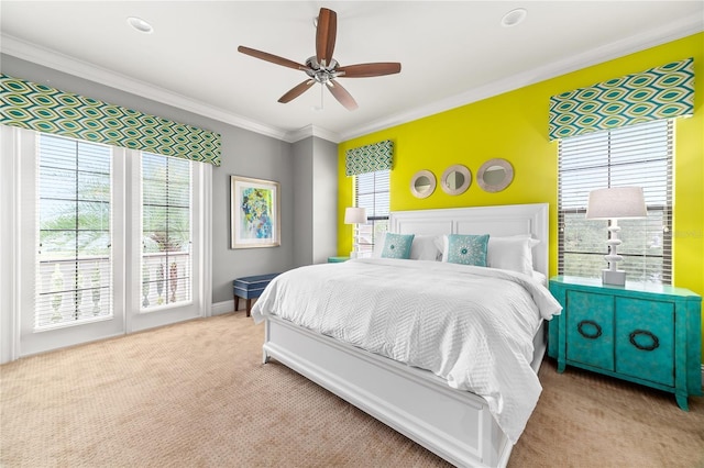 bedroom with light colored carpet, ceiling fan, and crown molding