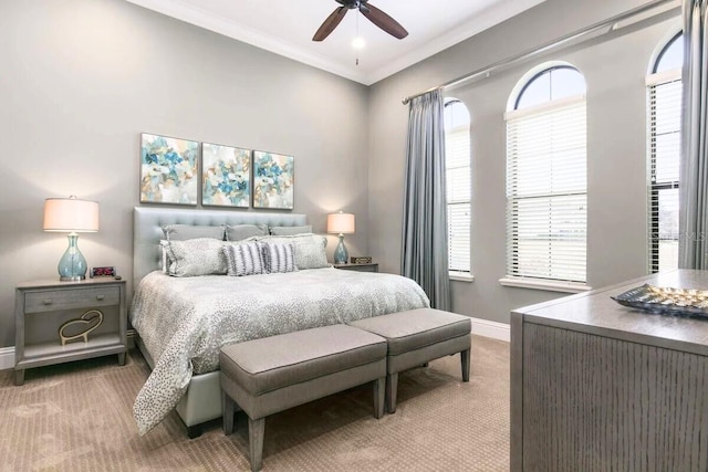 carpeted bedroom with ceiling fan and crown molding