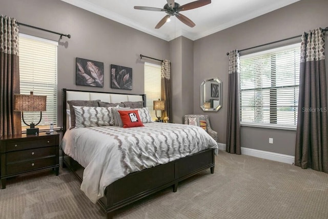 carpeted bedroom featuring ceiling fan and ornamental molding