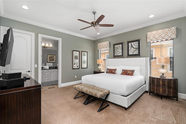 carpeted bedroom with ceiling fan, crown molding, and ensuite bath