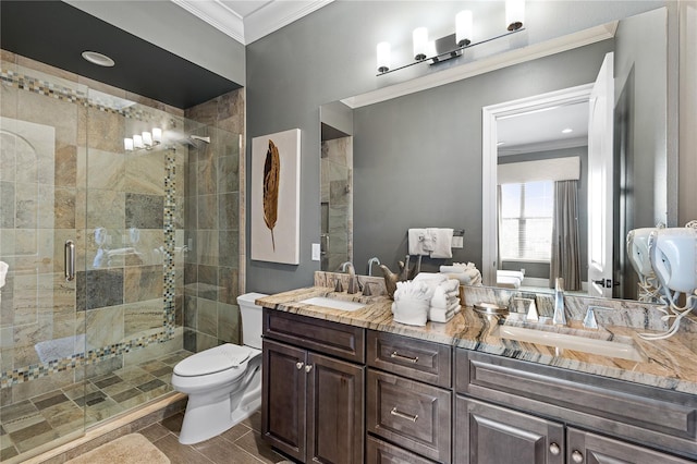 bathroom featuring vanity, toilet, an enclosed shower, and crown molding