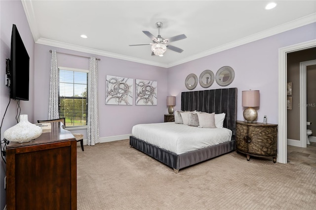 bedroom with ensuite bath, ceiling fan, light carpet, and ornamental molding