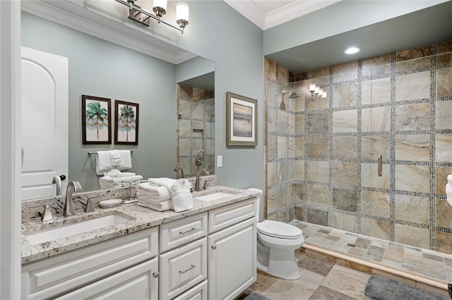 bathroom featuring toilet, vanity, a shower with shower door, and ornamental molding