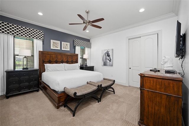 bedroom featuring a closet, light colored carpet, ceiling fan, and crown molding