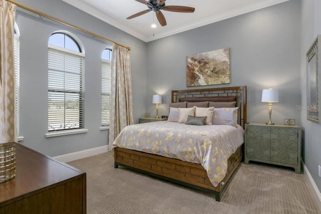 carpeted bedroom featuring ceiling fan and ornamental molding