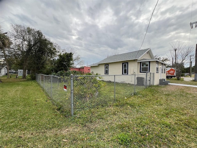 view of side of home with a lawn