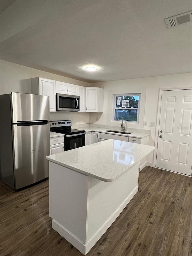 kitchen featuring white cabinetry, sink, dark hardwood / wood-style floors, and appliances with stainless steel finishes