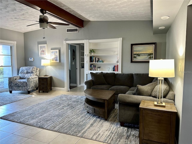 tiled living room featuring ceiling fan, lofted ceiling with beams, built in features, and a textured ceiling