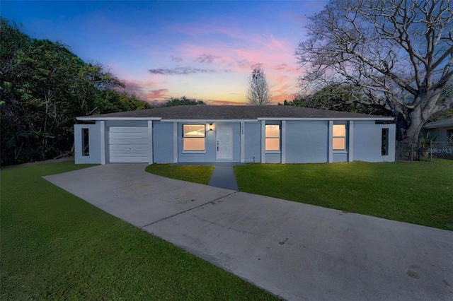 single story home with a yard and a garage