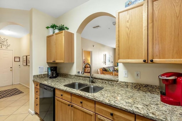 kitchen with sink, black dishwasher, light brown cabinetry, light tile patterned flooring, and light stone counters